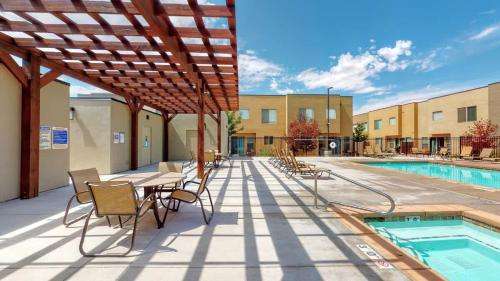 a patio with a table and chairs next to a pool at Entrada at Moab #640 in Moab