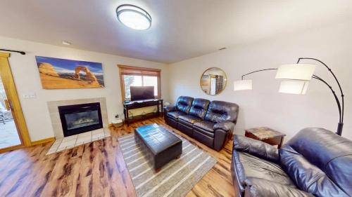 a living room with leather furniture and a fireplace at The Rock #3461 in Moab