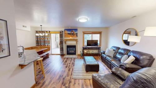 a living room with a leather couch and a fireplace at The Rock #3461 in Moab