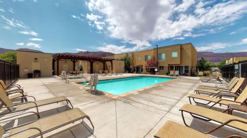 a pool with chaise lounge chairs and a resort at Entrada at Moab #668 in Moab