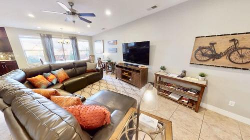 a living room with a leather couch and a tv at Entrada at Moab #668 in Moab