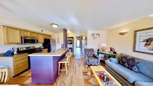 a kitchen and a living room with a blue couch at Sunset View #3234 in Moab