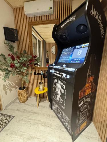 a video game machine with a bottle of wine in a room at Le Refuge in Margencel