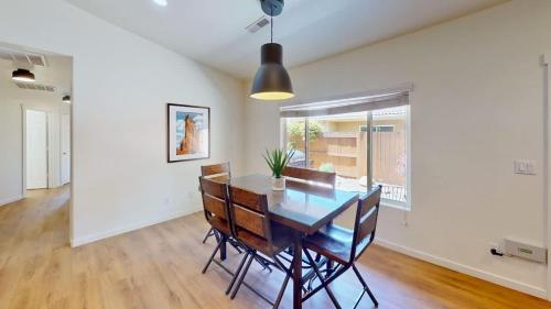a dining room with a glass table and chairs at Portal Vista #443 in Moab