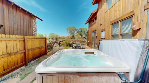 a hot tub in a yard next to a building at Coyote Run #4 in Moab