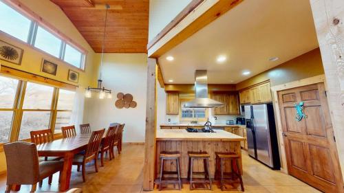 a kitchen and dining room with a table and chairs at Coyote Run #4 in Moab