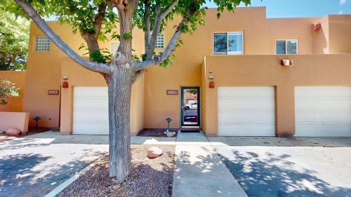 a building with two garage doors and a tree at Henning's Escape #3328 in Moab