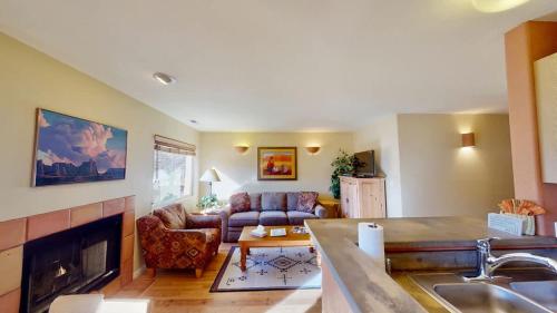 a living room with a couch and a fireplace at Kokopelli's Kiva #3230 in Moab
