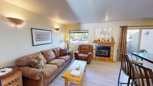 a living room with a couch and a fireplace at Kokopelli Dream #3251 in Moab