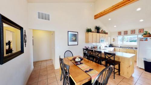 a kitchen and dining room with a wooden table and chairs at Jan's Joy #N3 in Moab
