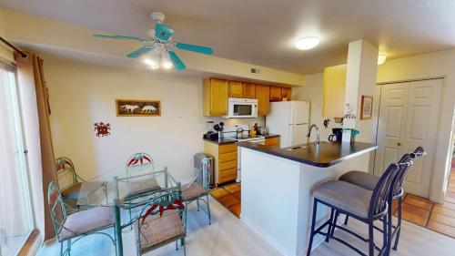 a kitchen with a table and chairs and a ceiling fan at Kokopelli Dream #3251 in Moab