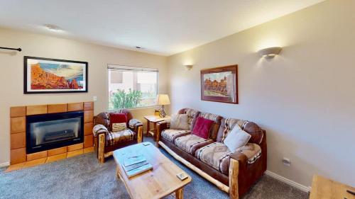 a living room with a couch and a fireplace at River Days #3326 in Moab