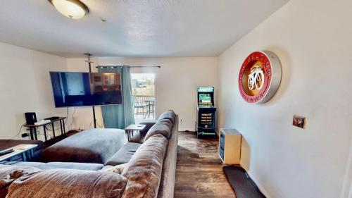 a living room with a couch and a flat screen tv at Red Cliff Condos #1H in Moab