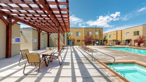 a patio with a table and chairs next to a pool at Entrada at Moab #628 in Moab