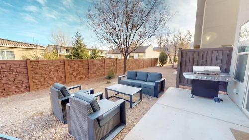 a backyard with furniture and a grill and a fence at Entrada at Moab #430 in Moab