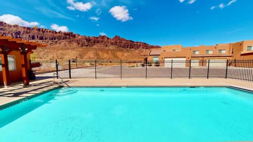 a large swimming pool in front of a fence at Slick Rock Reserve #12A3 in Moab