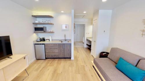 a living room with a couch and a kitchen at Slot Canyon #B in Moab