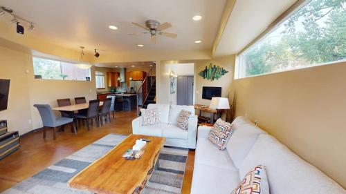 a living room with a white couch and a table at Millcreek on Main in Moab