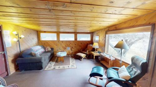 a living room with a couch and chairs in a cabin at Pack Creek ~ Trails End in Spanish Valley