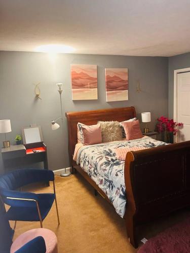 a bedroom with a bed and a blue chair at The Haven at Charity House in Waldorf