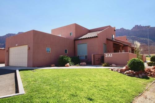 a house with a lawn in front of it at Saddle Creek #3A1 in Moab