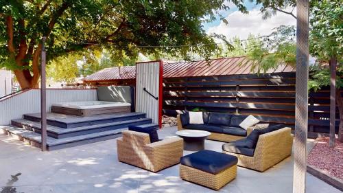 a patio with chairs and a bed and a table at Moab Flats #7 in Moab