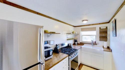 a kitchen with a stove and a refrigerator at Pack Creek ~ Creekside West in Moab