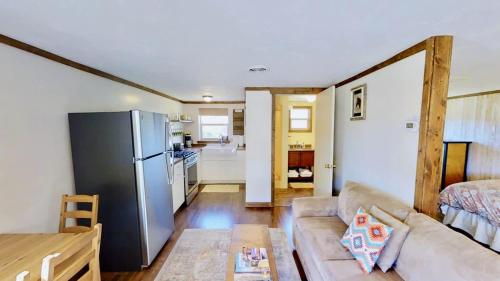 a living room with a couch and a refrigerator at Pack Creek ~ Creekside West in Moab