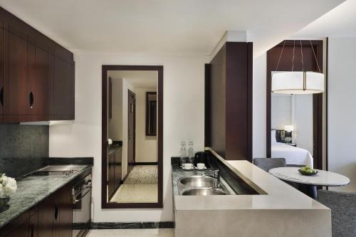 a kitchen with a sink and a counter top at Dusit Thani Dubai in Dubai
