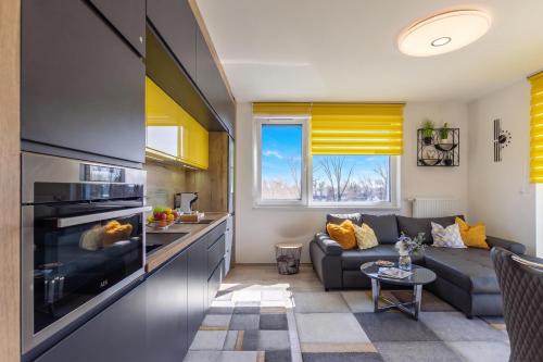 a kitchen and living room with a couch and a stove at Sunset Resort 409 With Pool - Happy Rentals in Fonyód
