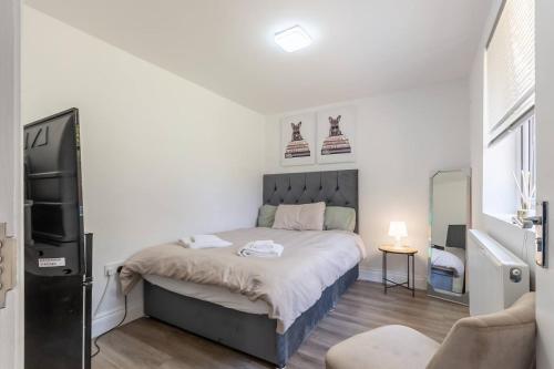 a bedroom with a bed with shoes on the wall at Comfortable 2 Bed Apartment- Pass the Keys in Basildon