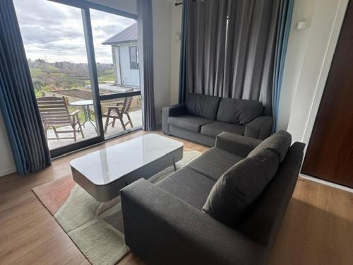 a living room with a couch and a table at 1 Bedroom Granny Flat D in Runciman