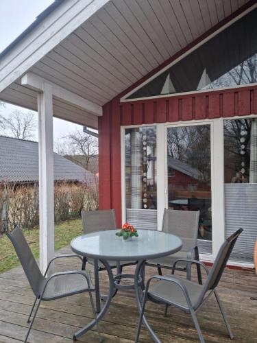 a patio with a table and chairs on a deck at Ferienhaus Fuchsbau in Extertal