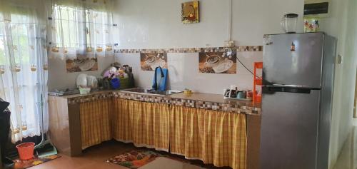 a kitchen with a sink and a refrigerator at Bethany in Rivière Dragon