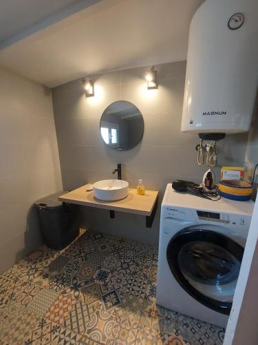a small bathroom with a washing machine and a sink at Marialena's houses in Methoni