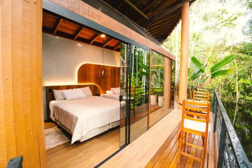 a master bedroom with a bed on a deck at Cirandeira Amazon World EcoResort in Manacapuru