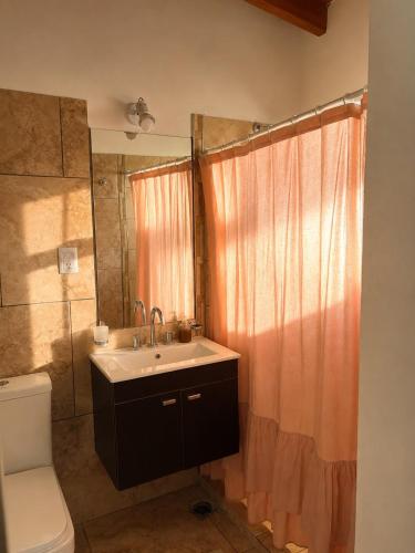 a bathroom with a sink and a toilet and a shower at Complejo GOOD LIFE in Miramar
