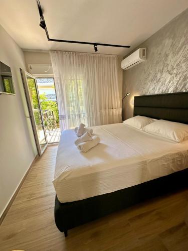a bedroom with a bed with a teddy bear on it at SMART COASTAL RETREAT Apartment in Alexandroupoli