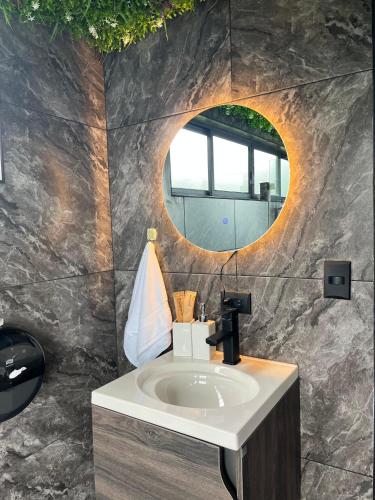 a bathroom with a sink and a mirror at Ecoesferas Glamping in La Ese