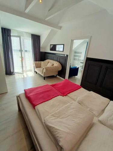 a large bed in a living room with a couch at VILLA KINGA ROWy in Rowy