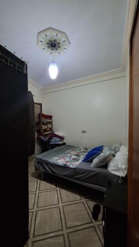 a bedroom with a bed in a room with a ceiling at Mini-villa ajdir in Ajdir