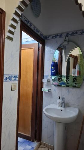 a bathroom with a sink and a mirror at Mini-villa ajdir in Ajdir