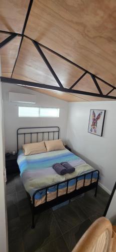 a bedroom with a bed with a wooden ceiling at Studio in Quindalup bay in Quindalup