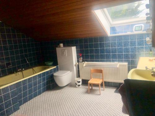 a bathroom with a toilet and a tub and a sink at Only Lady Kaarst in Kaarst