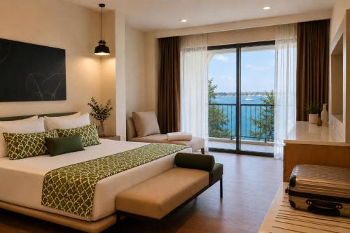 a bedroom with a large bed and a balcony at Bluezone Club Residences by A'ila Resorts in Rodney Bay Village
