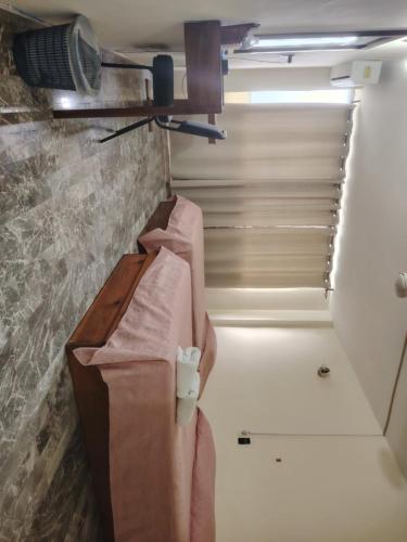 a bathroom with a sink and a light on a wall at Hotel la fortuna in Tuxpan de Rodríguez Cano