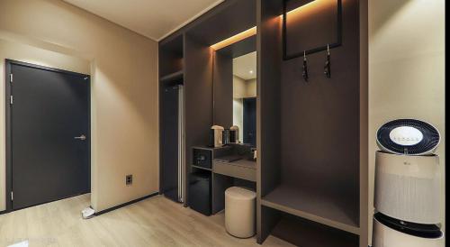 a room with a bathroom with a sink and a mirror at Hotel RIL in Gwangju