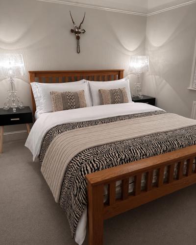 a bedroom with a large bed with two lamps at Copeland House 4 Island Wall in Whitstable