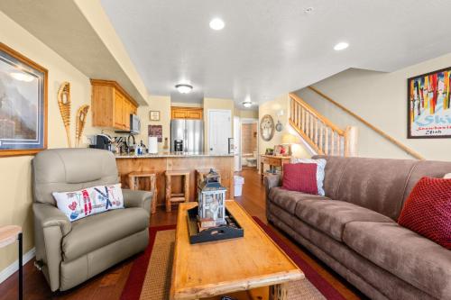 a living room with a couch and a table at Basin Lakeside Getaway MH702Near Powder Mtn Hot Tub in Eden