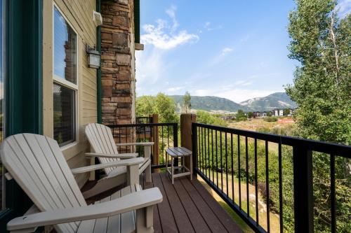 two chairs sitting on the porch of a house at Basin Lakeside Getaway MH702Near Powder Mtn Hot Tub in Eden